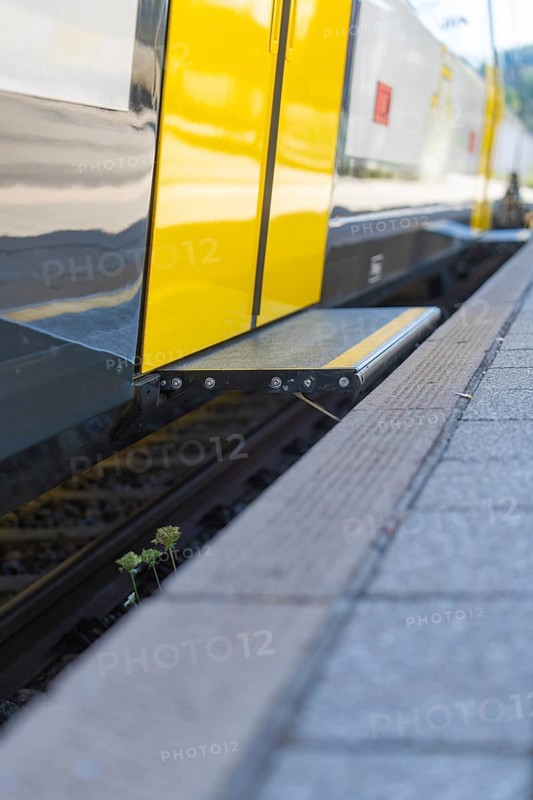 Close-up of a yellow train at a platform edge with track in the foreground, battery Electric train with green electricity, Siemens Mireo Plus B, Freudenstadt, Germany