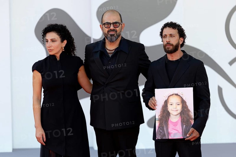 Venice, Italy - 3 September 2025: Clara Khoury, Amer Hlehel, Motaz Malhees with a portrait of five-year-old Palestinian girl Hind Rajab, who was killed by the Israeli army in the Gaza Strip in January 2024, during the red carpet of - The Voice Of Hind Rajab - during the 82nd Venice International Film Festival