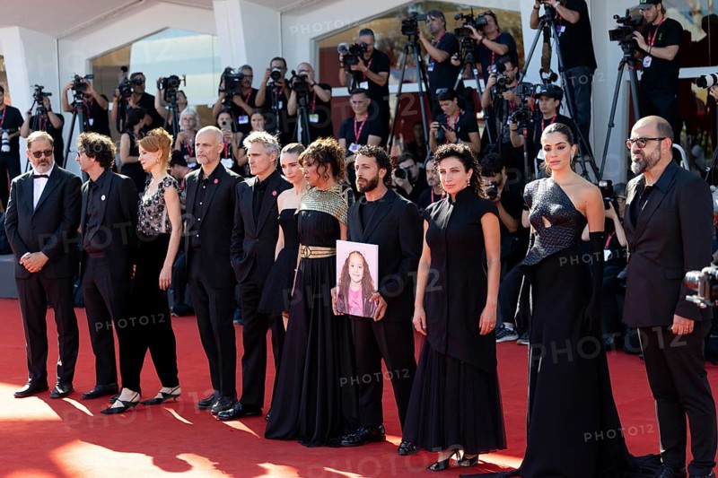 Venice, Italy - 3 September 2025: Nadim Cheikhrouha, Odessa Rae, James Wilson, Joaquin Phoenix, Mara Rooney, Kaouther Ben Hania, Motaz Malhees and Clara Khoury with a portrait of five-year-old Palestinian girl Hind Rajab, who was killed by the Israeli army in Gaza in January 2024, during the Red Carpet of - The Voice Of Hind Rajab - during the 82nd Venice International Film Festival