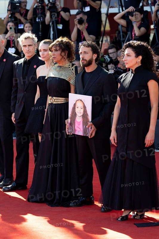 Venice, Italy - 3 September 2025: Joaquin Phoenix, Rooney Mara, Kaouther Ben Hania, Motaz Malhees, Clara Khoury with a portrait of the five-year-old Palestinian girl Hind Rajab, who was killed by the Israeli army in Gaza in January 2024, during the Red Carpet of - The Voice Of Hind Rajab - during the 82nd Venice International Film Festival