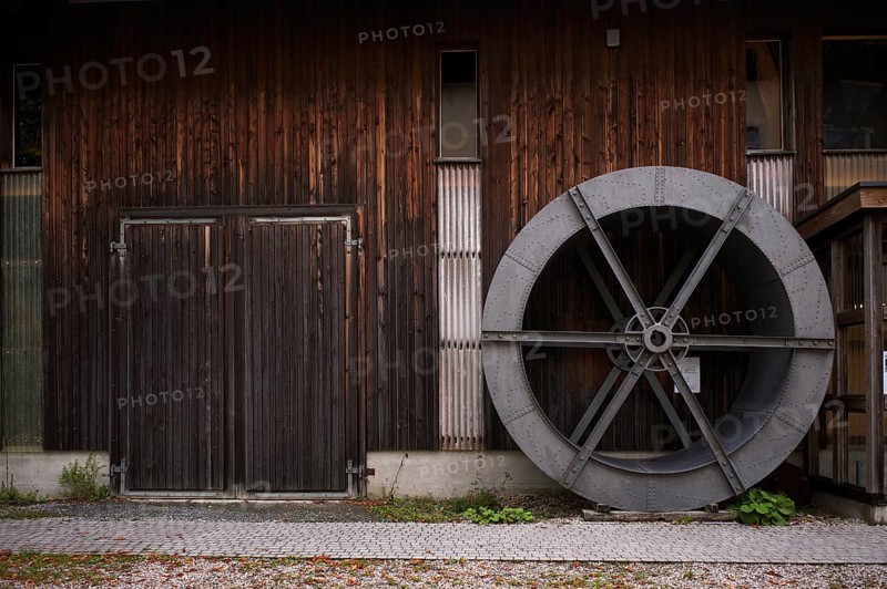 Historic wheel for processing grain, organic farm, Burgrain adventure farm near Willisau, Agrovision Burgrain AG, Canton of Lucerne, Switzerland