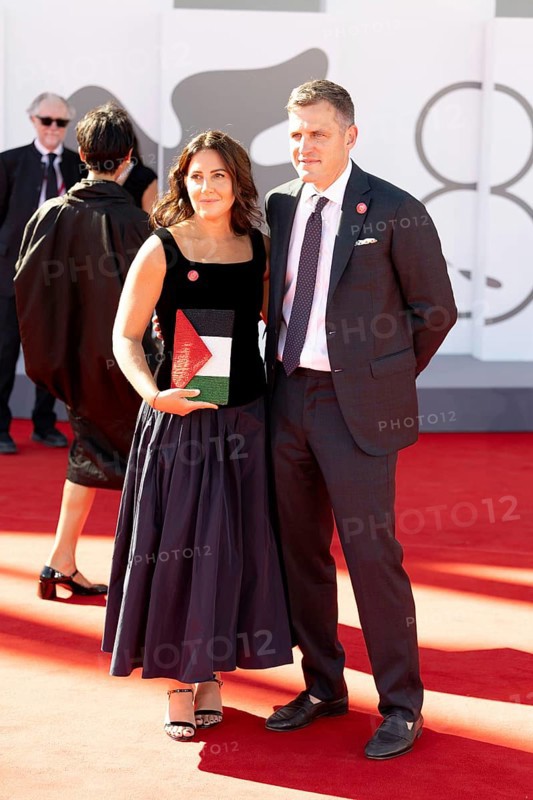 Venice, Italy - 3 September 2025: A guest carries a handbag designed in the colours of the Palestinian flag during the red carpet of - The Voice Of Hind Rajab - during the 82nd Venice International Film Festival