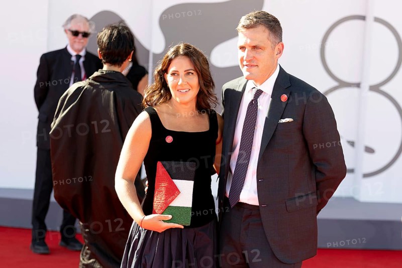 Venice, Italy - 3 September 2025: A guest carries a handbag designed in the colours of the Palestinian flag during the red carpet of - The Voice Of Hind Rajab - during the 82nd Venice International Film Festival