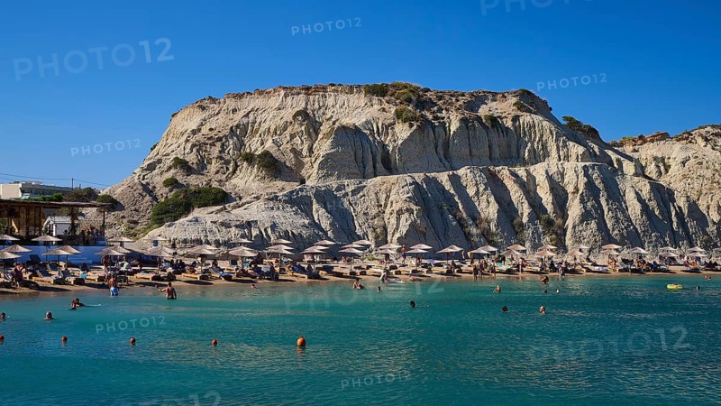 Lively beach against a rocky backdrop with bathing facilities and numerous parasols, Limanaki Beach, sandstone cliffs, Kolymbia, Rhodes, Dodecanese, Greek Islands, Greece