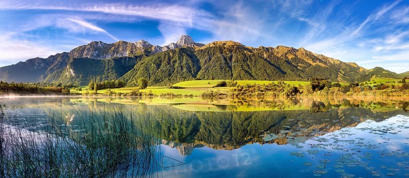 Stockhorn range with the Stockhorn mountain reflected in the Uebeschi lake in the morning light, Gürbetal, Canton of Bern, Switzerland