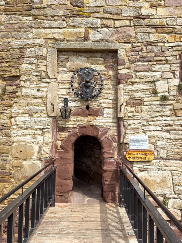 View over fortified bridge to historic small narrow castle gate Access to castle courtyard of 13th century Trendelburg Castle, today Burghotel Trendelburg, Trendelburg, Weserbergland, Hesse, Germany