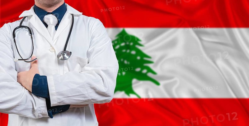 Male doctor with stethoscope on Lebanese flag. Doctor holding stethoscope on Lebanon flag