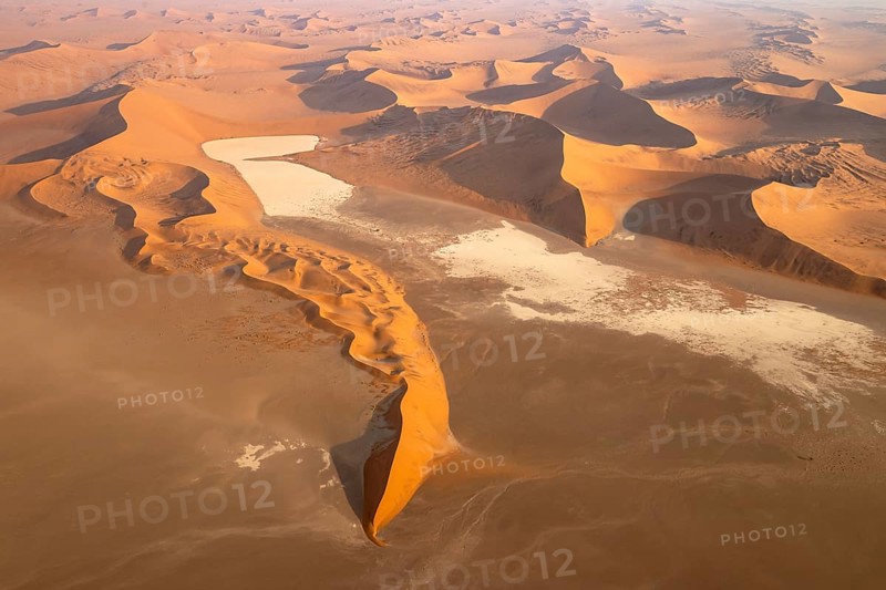 Sand dunes and dry pans in the Namib Desert. In the evening. Aerial view. Namib-Naukluft Park, Namibia