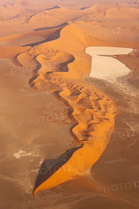 Sand dunes and dry pans in the Namib Desert. In the evening. Aerial view. Namib-Naukluft Park, Namibia