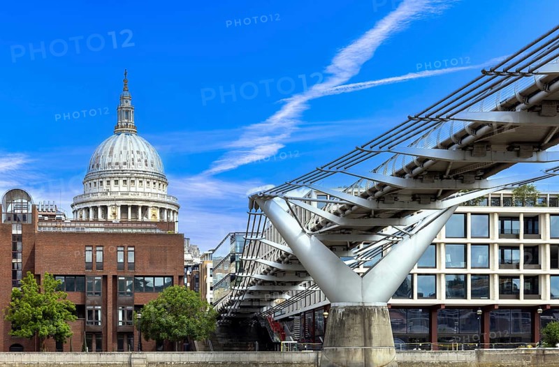 Millennium Bridge in London city financial business center, view from the River Thames