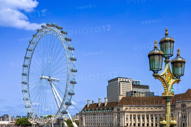 Travel attraction of London Eye Millenium ferris wheel overlooking London Big Ben and British Parliament