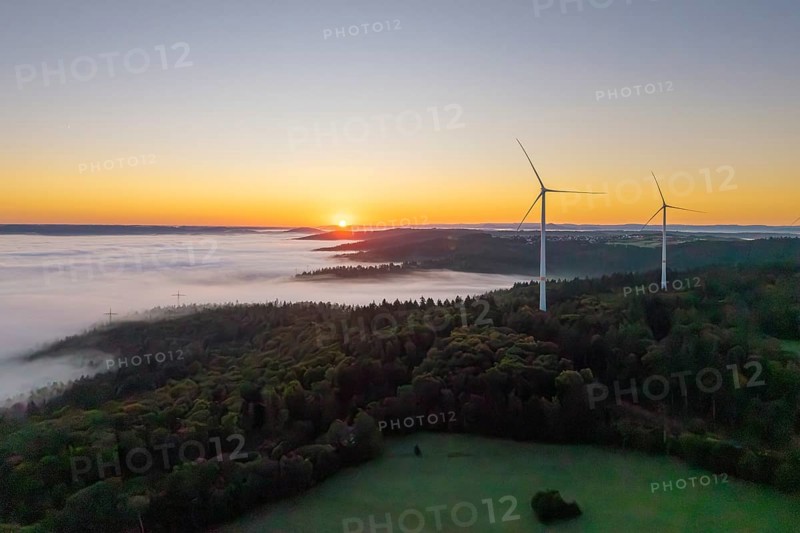 Wind turbines at sunrise over a misty forest landscape, near Schorndorf, Rems-Murr district, Rems-Murr-Kreis, Baden-Württemberg, Germany