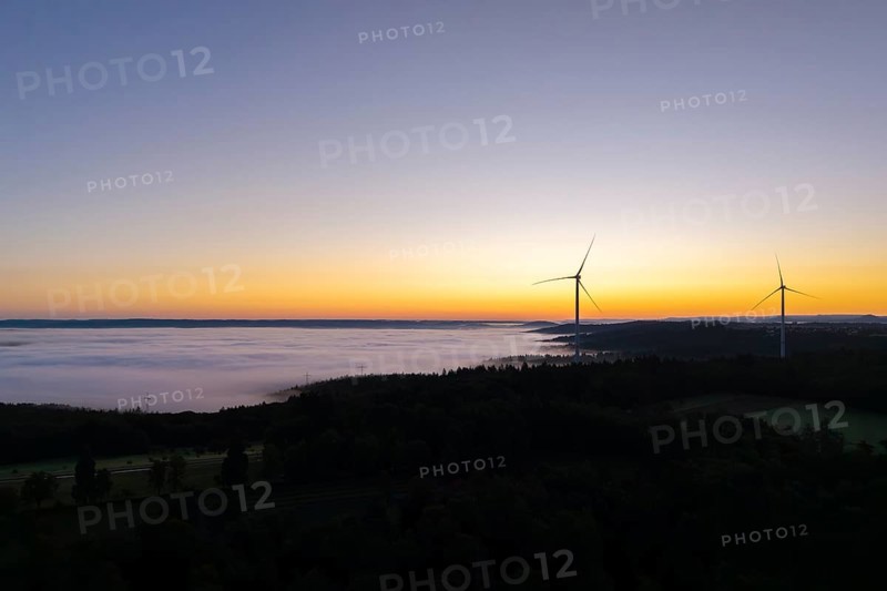 Darker morning sky with wind turbines and fog in the foreground, near Schorndorf, Remstal, Rems-Murr-Kreis, Baden-Württemberg, Germany