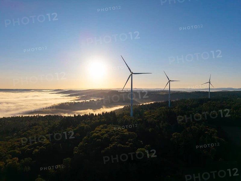 Three wind turbines stand in the early morning light above a misty valley, near Schorndorf, Rems-Murr district, Rems-Murr-Kreis, Baden-Württemberg, Germany