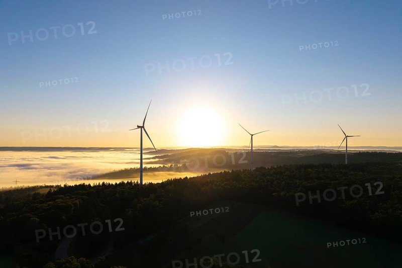 Three wind turbines in the soft morning light over a misty forest landscape, near Schorndorf, Rems-Murr district, Rems-Murr-Kreis, Baden-Württemberg, Germany