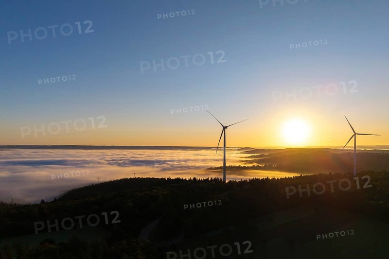 Two wind turbines rise above a fog-covered landscape in the morning light, near Schorndorf, Rems-Murr district, Rems-Murr-Kreis, Baden-Württemberg, Germany