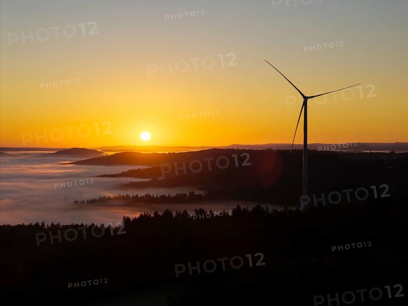 Impressive sunrise with wind turbine over foggy forest, near Schorndorf, Remstal, Rems-Murr-Kreis, Baden-Württemberg, Germany