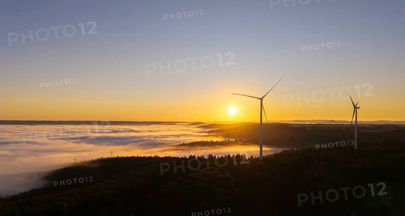 Wind turbines stand in the morning mist under a clear sunrise sky, near Schorndorf, Rems-Murr district, Rems-Murr-Kreis, Baden-Württemberg, Germany