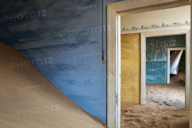 At Kolmanskop, the abandoned ghost town of the diamond days of the early 1900 and of German origin. Inside the restricted Diamond Area east of the coastal town of Lüderitz. Namib Desert, Namibia