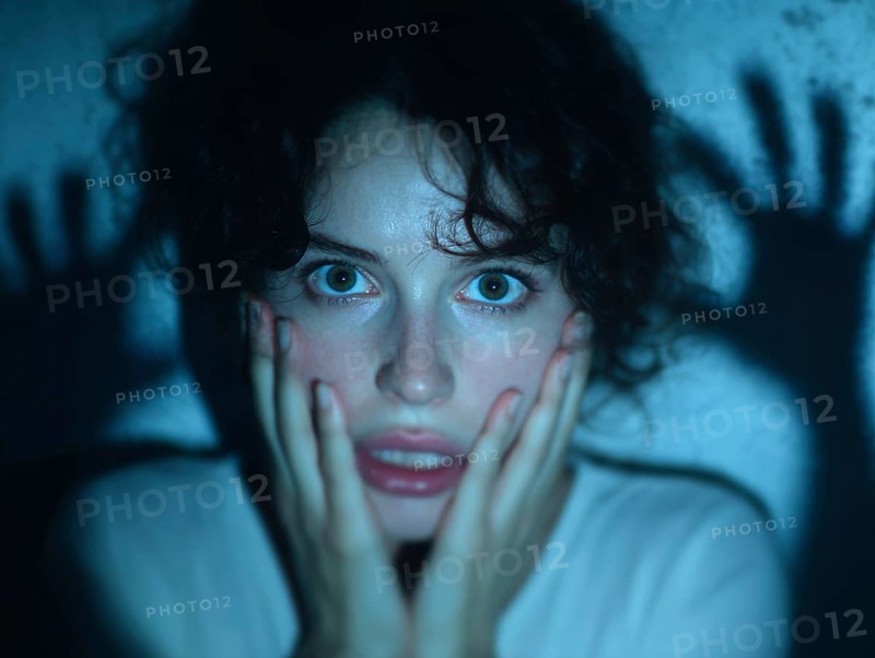 A woman shows a frightened expression on her face while shadowy hands are placed over her, symbolising anxiety disorders, panic attacks, mental illness, AI generated, AI generated