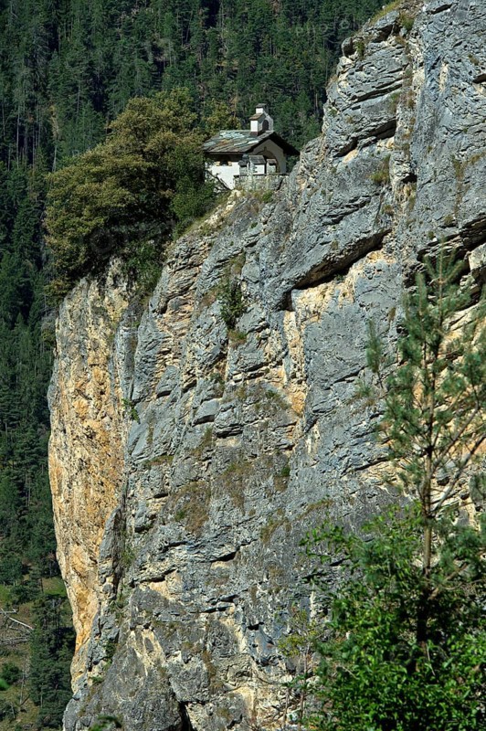 The small Chapelles des Pontis chapel on a rocky outcrop on the precipice, Chandolin, Val d'Anniviers, Valais, Switzerland