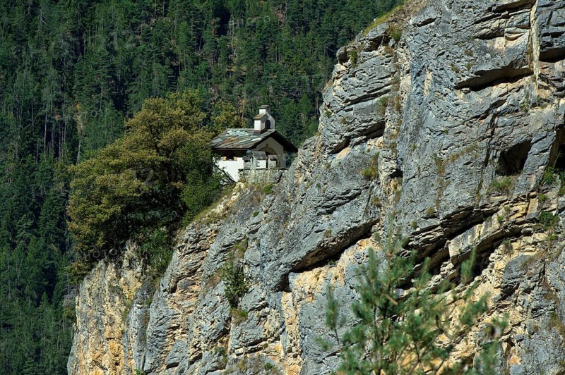 The small Chapelles des Pontis chapel on a rocky outcrop on the precipice, Chandolin, Val d'Anniviers, Valais, Switzerland