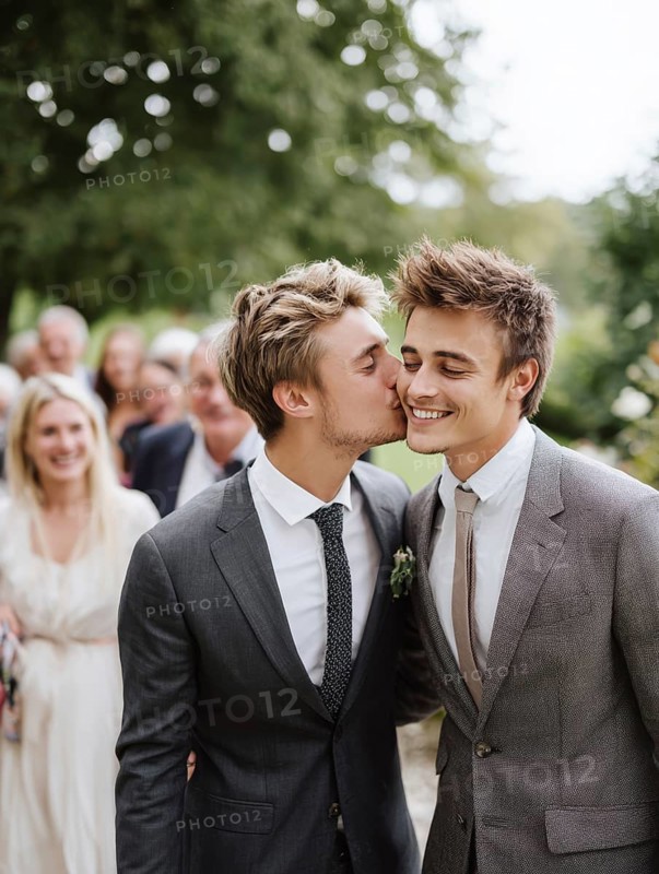 A male couple in a suit, one kissing the other on the cheek, surrounded by guests outdoors, symbolising same-sex marriage, love, LGBTQ, AI generated, AI generated
