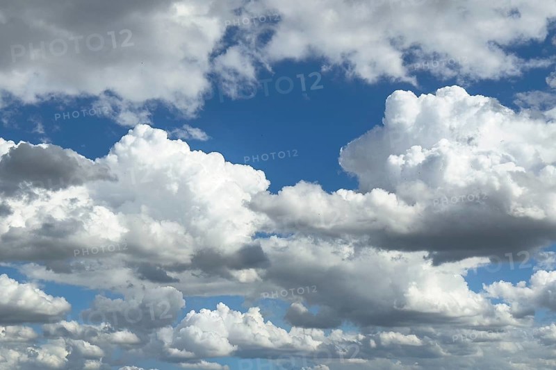 Many white altocumulus clouds cluster clouds under a bright blue sky can be seen through gaps in the cloud cover, internationally