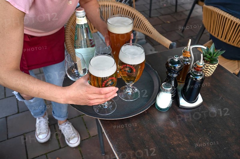 Waitress brings drinks in a garden restaurant, Munich, Bavaria, Germany