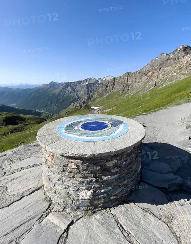 Front orientation board on stone plinth at viewpoint on third highest asphalted pass in the Alps highest border pass 2744 m high Col Agnel Colle dell' Agnello Pass in the high Alps Alpine pass above tree line via southern ascent mountain road Alpine road, Col Agnel, Colle dell'Agnello, Pontechianale, Piedmont, Italy