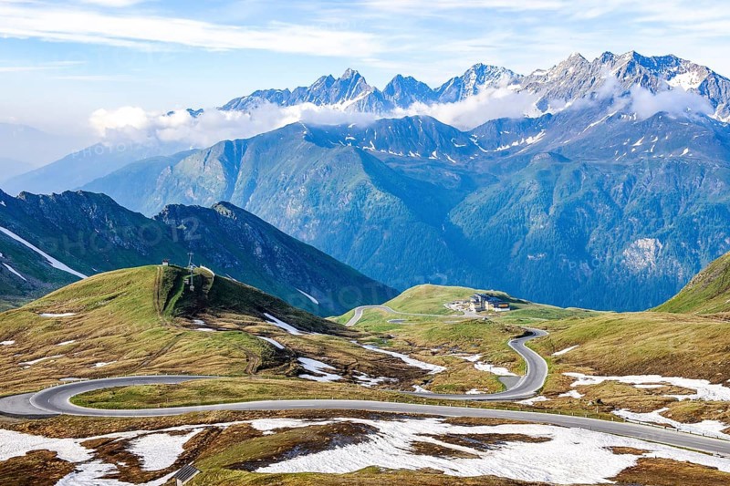 View to the south from Hochtor pass summit of Grossglockner High Alpine Road to high plateau with serpentines of winding Alpine road mountain road pass road Alpine pass behind mountain range Grossglockner Group, Carinthia, Austria