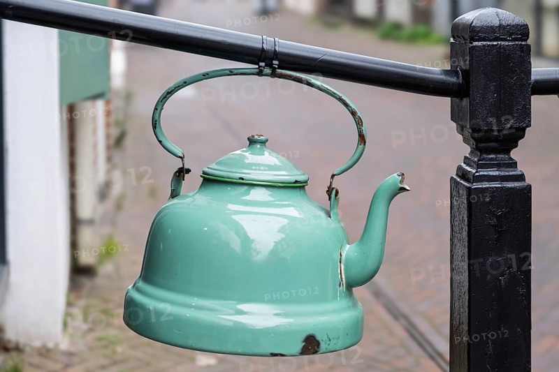 Old enamel tea or water kettle, decoration in front of a tea shop, province of Groningen, Netherlands