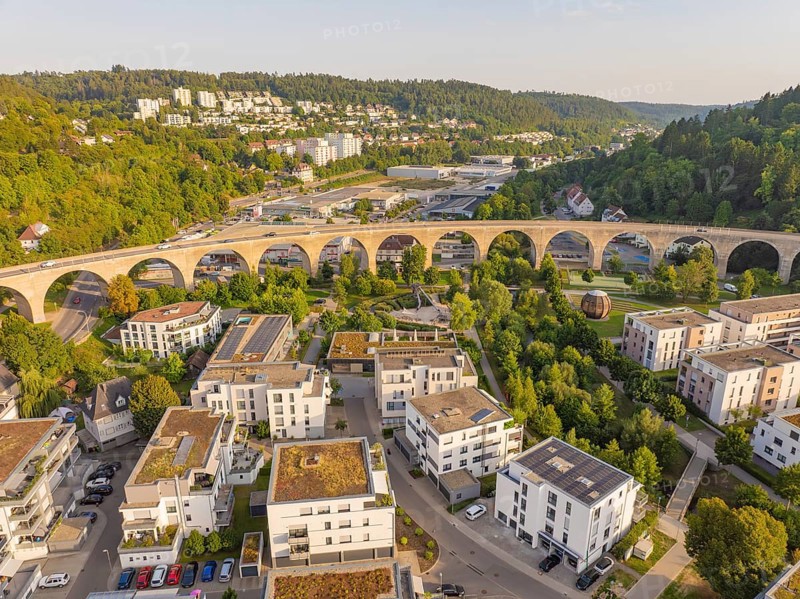Aerial view of a viaduct in the middle of a residential area and the surrounding forests, small town of Perle Nagold, Black Forest, Germany