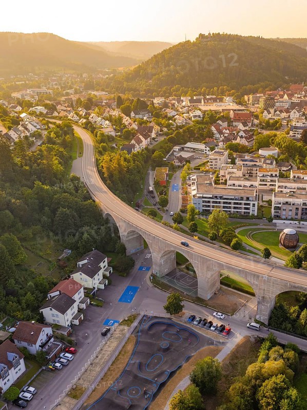 Bird's eye view of the town with viaduct and surrounding hills at sunset, small town Perle Nagold, Black Forest, Germany