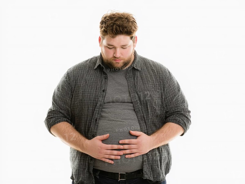 Overweight young man looks worried and holds his hands on his stomach, AI generated, AI generated