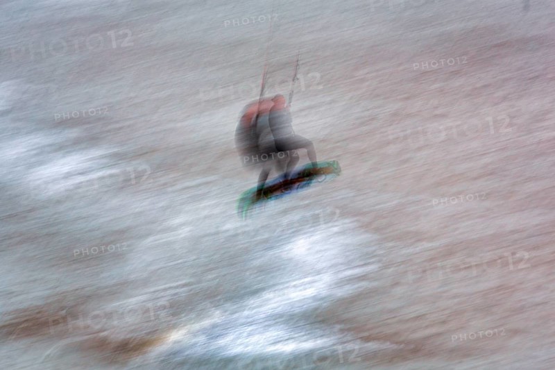 Kitesurfer jumping in the surf, wiping effect, long exposure, Sankt Peter-Ording, Eiderstedt peninsula, Wadden Sea National Park, North Frisia, Schleswig-Holstein, Germany