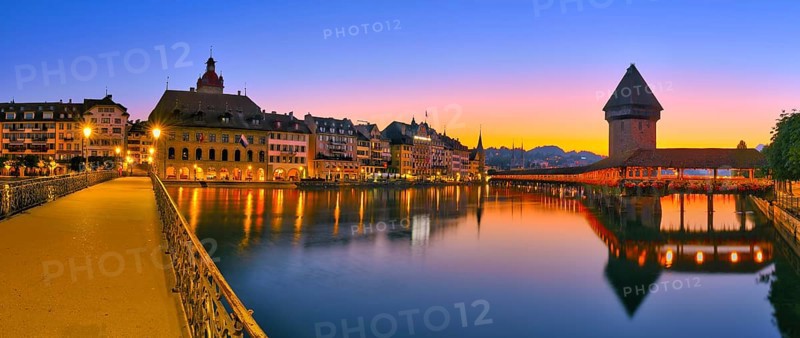 Chapel bridge with water tower reflected in the river Reuss, panorama of Lucerne's old town at dawn, Canton of Lucerne, Switzerland