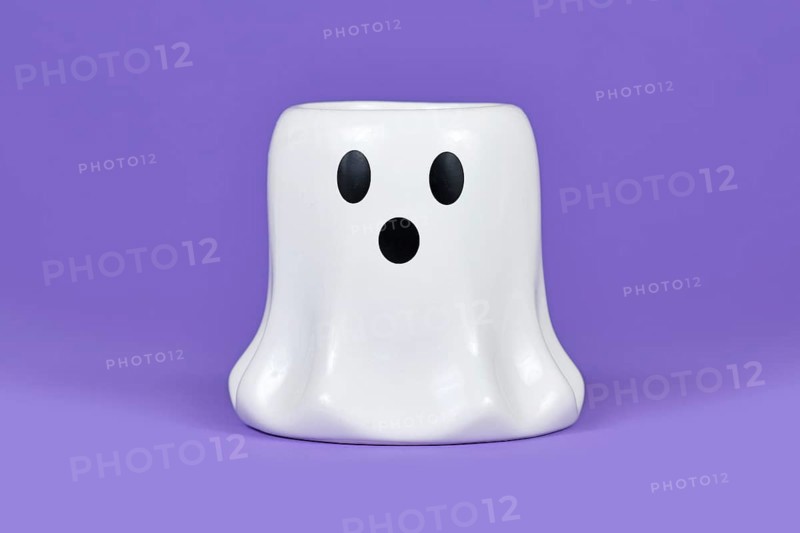 White Halloween ghost candle ornament on violet background