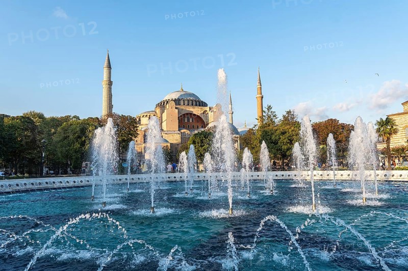 Fountains splashing water in front of the hagia sophia in istanbul, turkey, during a sunny day