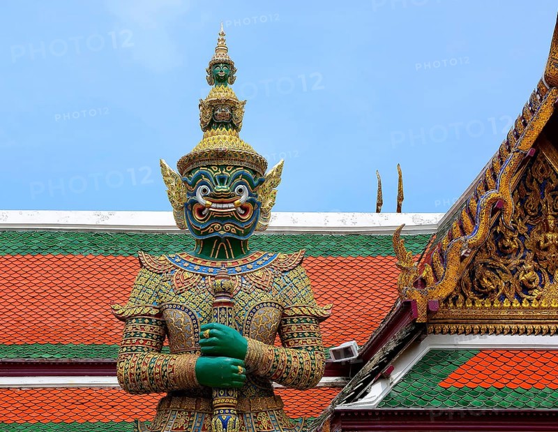 Colorful giant yaksha statue guarding the entrance of wat phra kaew, temple of the emerald buddha, grand palace, bangkok, thailand