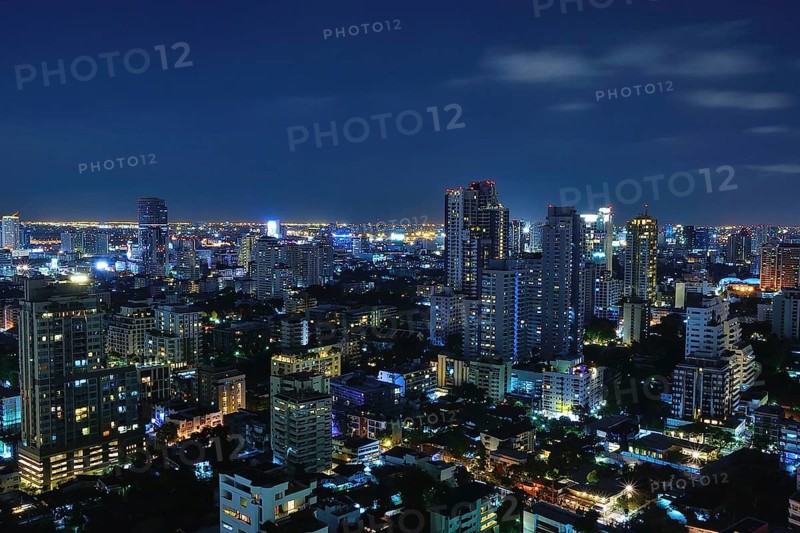 Bangkok's vibrant skyline at night, showcasing illuminated skyscrapers and bustling urban life in thailand's capital