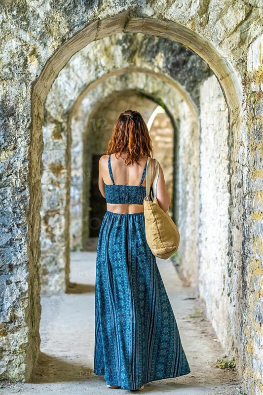Tourist admiring the arches of sauveterre de bearn in france, enjoying a summer vacation exploring historical landmarks