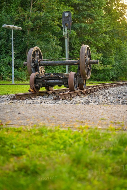 Two upturned train wheels on tracks against a green background. Atmosphere of peace and nature, Nagold, district of Calw, Black Forest, Germany