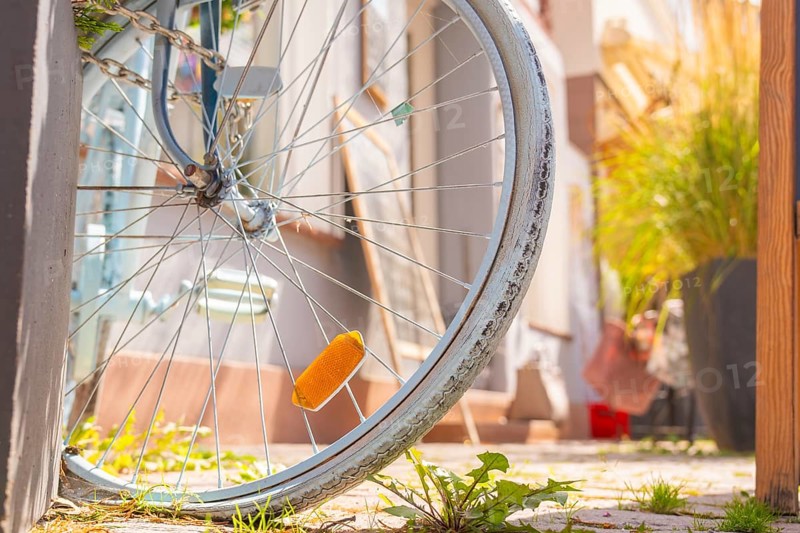 Close-up of a labelled bicycle tyre with green city pavement, small town of Perle Calw, district of Calw, Germany