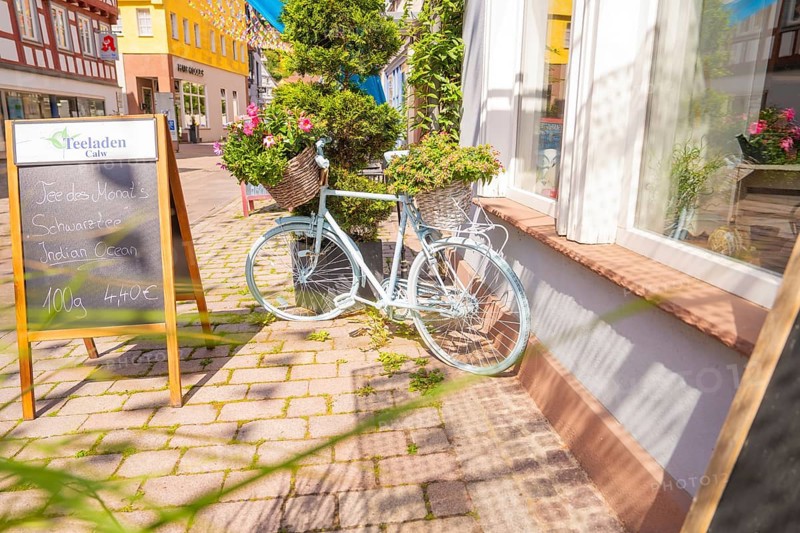 Scenes of a charming street with a pale bicycle and flowers, small town of Perle Calw, district of Calw, Germany