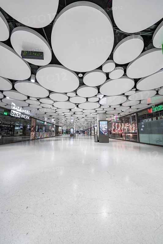 Light-flooded mall with modern round ceiling panels, Munich, Germany