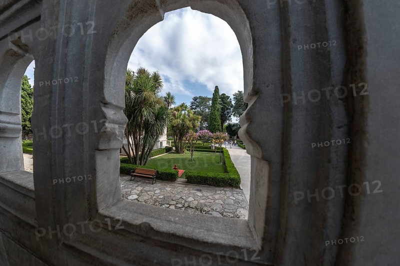 Lush gardens, framed by ornate stone arches, offer a tranquil escape in the heart of istanbul, turkey