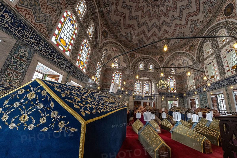Elaborate sarcophagi, adorned with intricate designs, lie within the suleymaniye mosque's mausoleum, showcasing ottoman artistry and history
