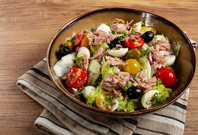 Salad with canned tuna, vegetable salad with quail eggs, lettuce, red onion, cherry tomatoes, olives, keto food, healthy food, homemade, no people