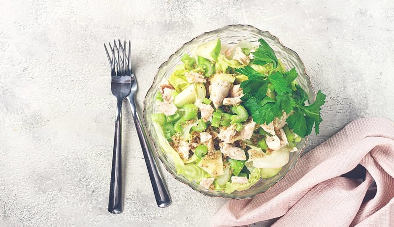 Waldorf salad, celery salad with apple, in a glass salad bowl, natural light, homemade, no people